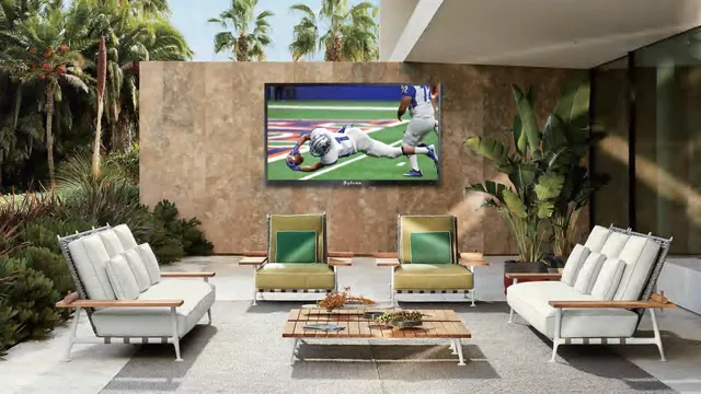 Sylvox outdoor television wall-mounted on a poolside terrace, screen legible in full daylight